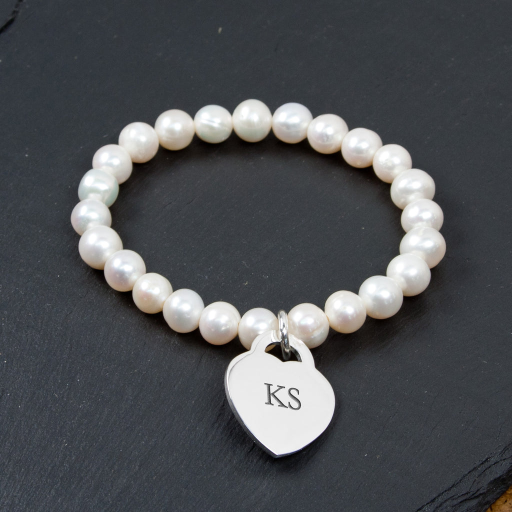 White pearl bracelet with engraved silver heart charm