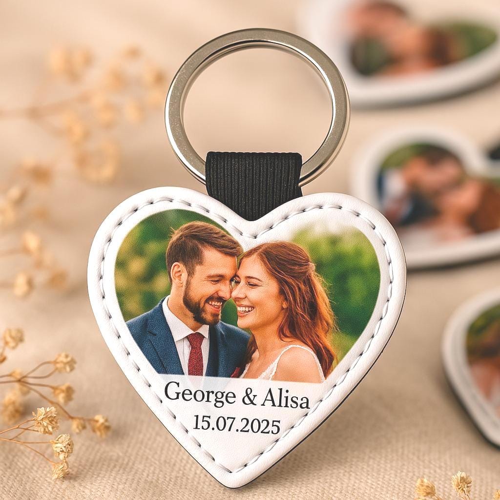 a heart shaped keychain with a picture of a couple on it