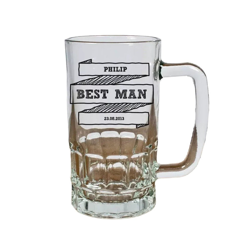 Clear glass mug with engraved text on a wooden surface