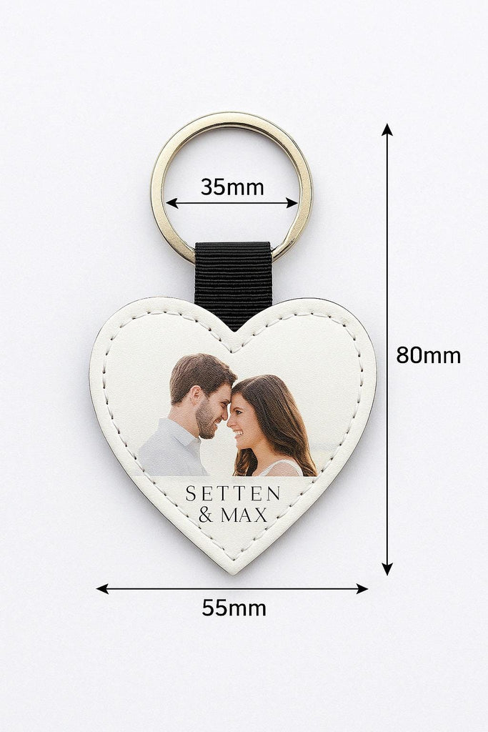 a heart shaped keychain with a picture of a couple on it