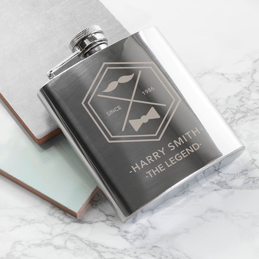 Personalized silver hip flask with engraved name and year, moustache design, stainless steel.