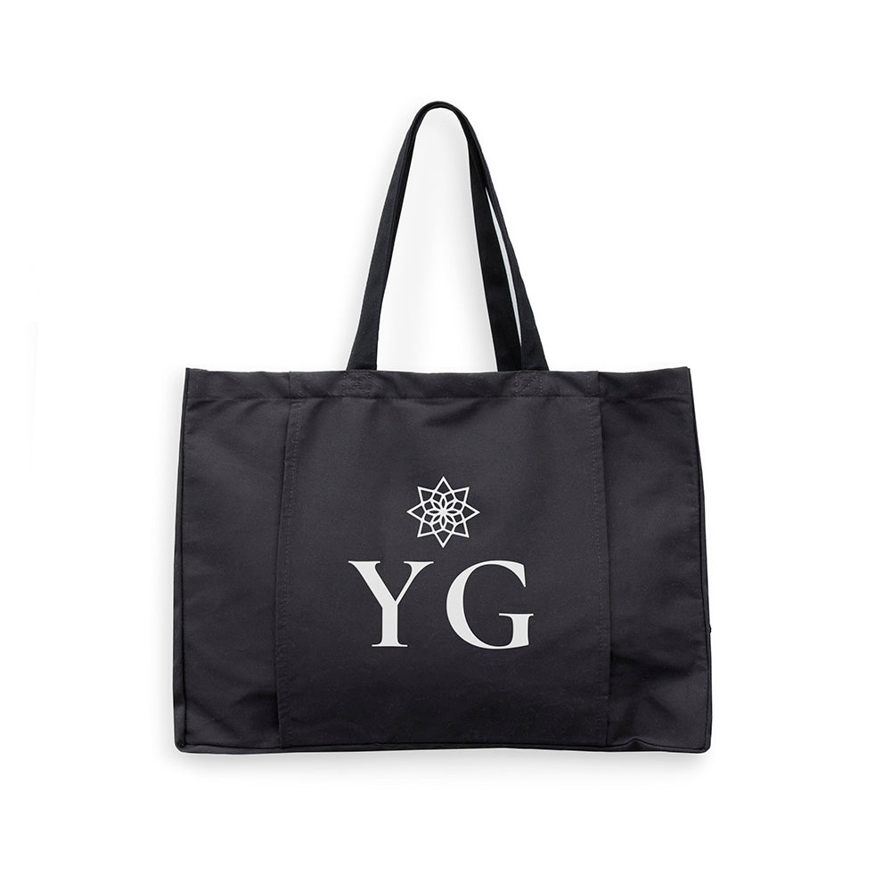 Black tote bag with 'YG' logo on a white background
