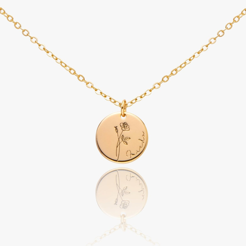 Gold necklace with engraved pendants on a white background