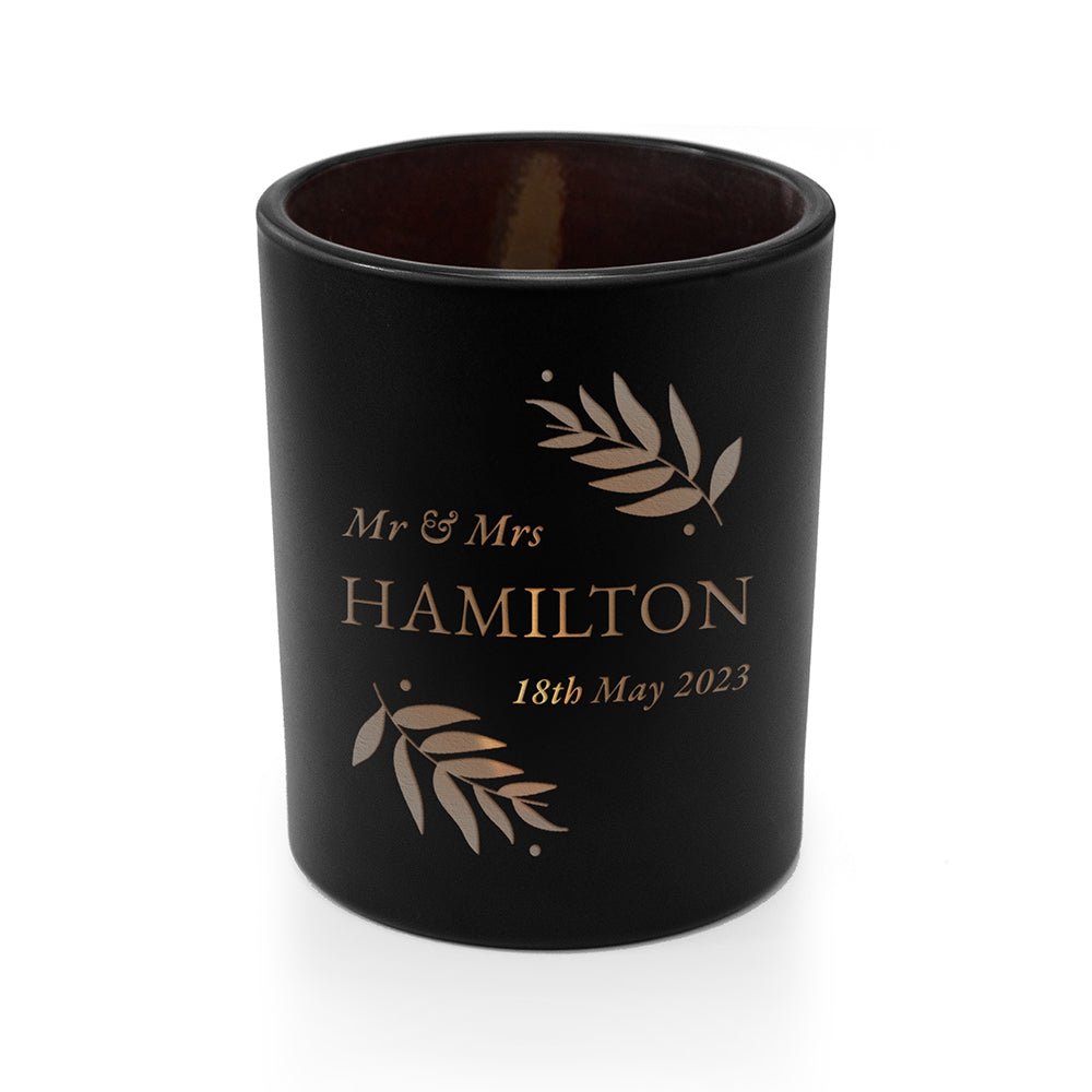 Black candle holder with 'Mr & Mrs Hamilton' and date engraving on a white background