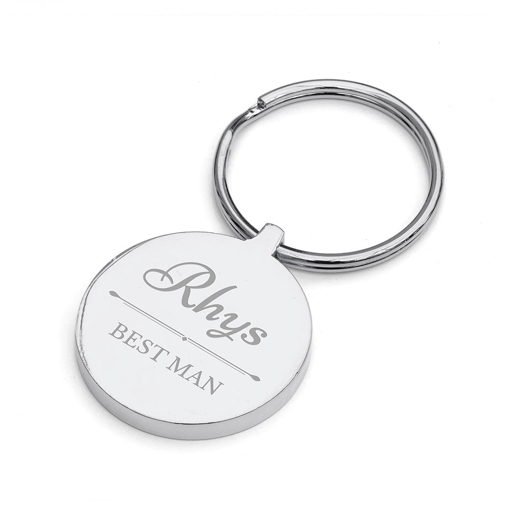 Silver keychain with engraved text on a white background