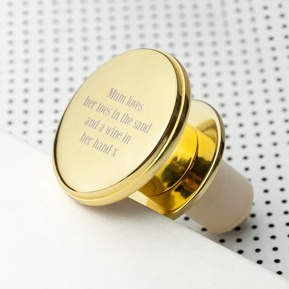 Gold ring with engraved text on a white surface