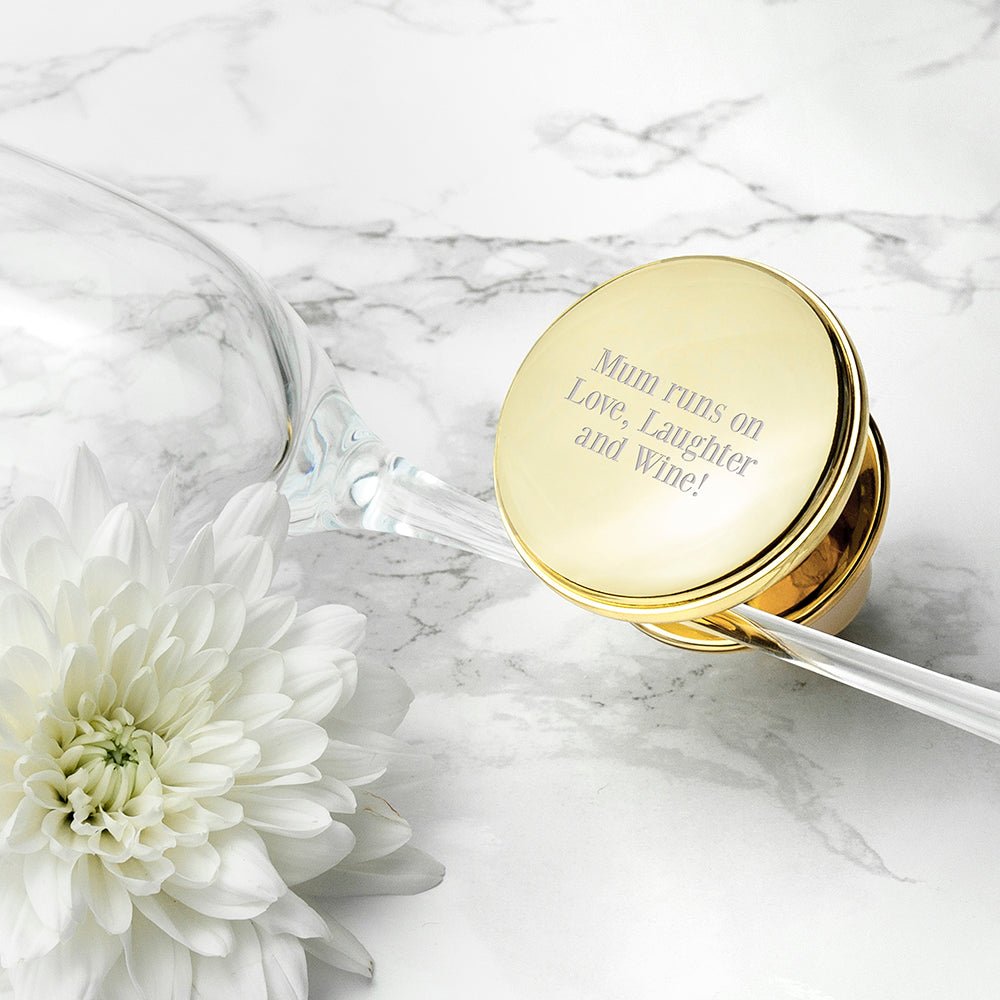 Gold container with a message on a marble surface with a white flower.