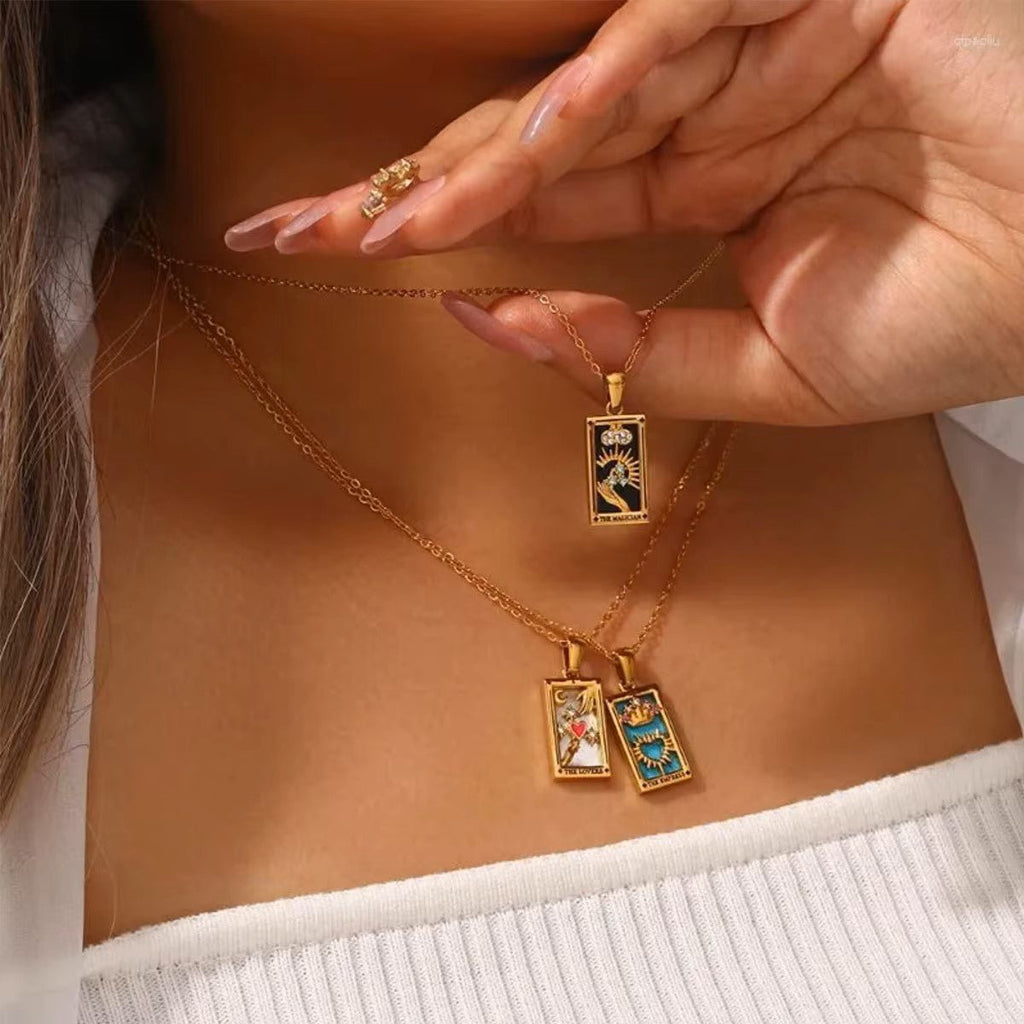 Gold necklaces with pendants on a person's neck