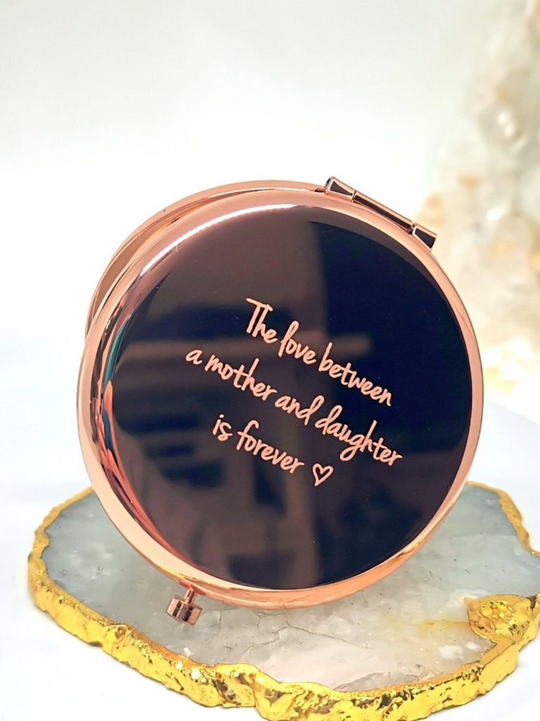 Personalized Rose Gold Handbag Mirror with engraving up to 150 characters. Features 70mm diameter, two mirrors (normal and magnifying), and button release. 
