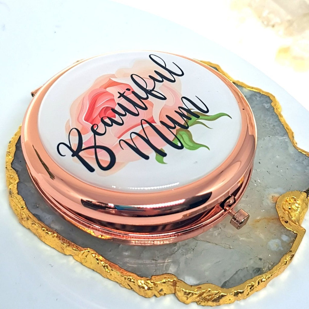 Personalized Rose Gold Handbag Mirror with engraving up to 150 characters. Features 70mm diameter, two mirrors (normal and magnifying), and button release. 