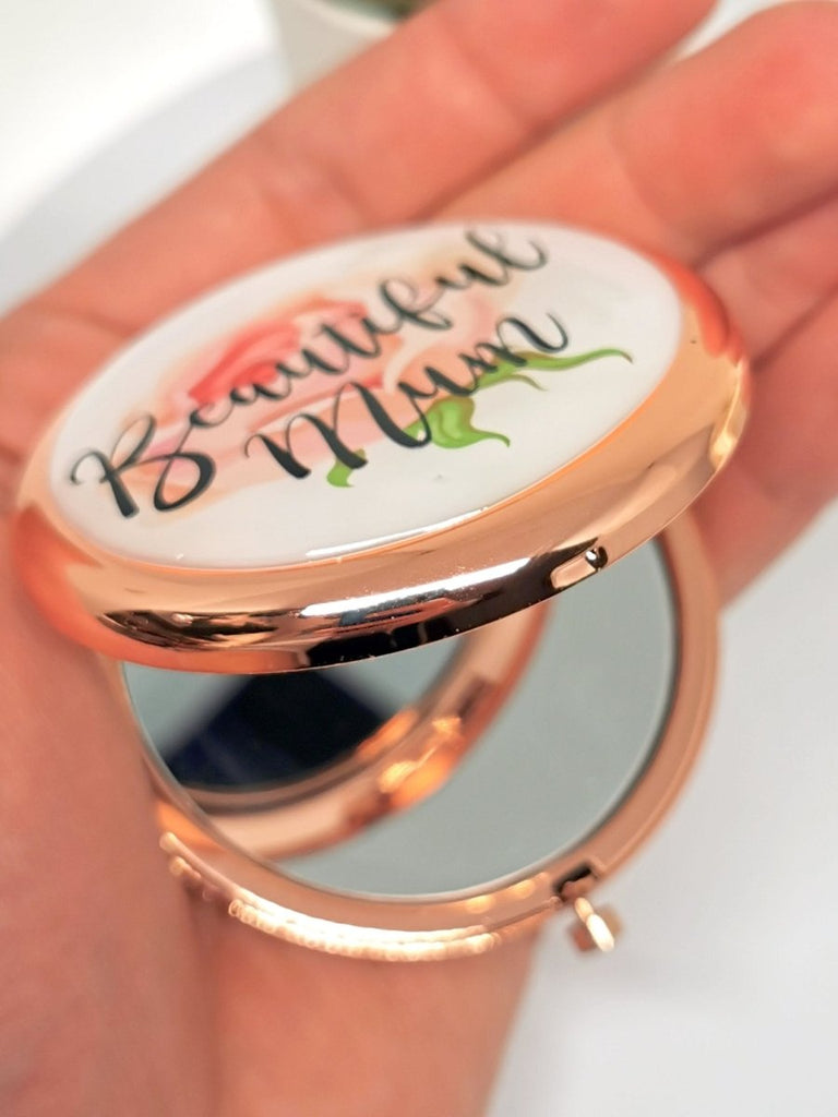 Personalized Rose Gold Handbag Mirror with engraving up to 150 characters. Features 70mm diameter, two mirrors (normal and magnifying), and button release. 