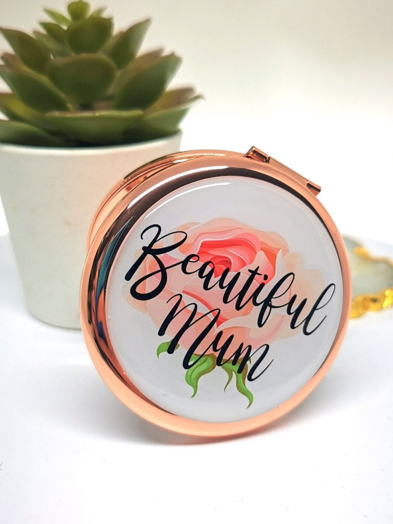 Personalized Rose Gold Handbag Mirror with engraving up to 150 characters. Features 70mm diameter, two mirrors (normal and magnifying), and button release. 