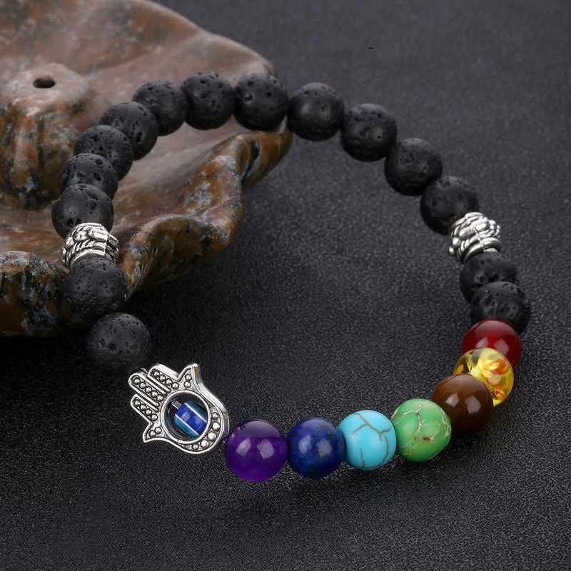 Chakra bead lava stone bracelet with evil eye charm, adjustable, spiritual protection, energy balancing.