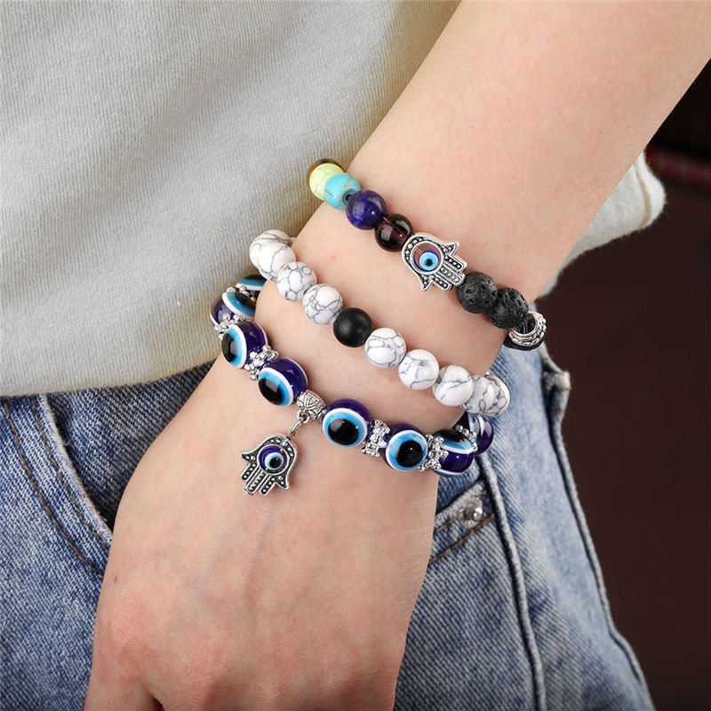 Chakra bead lava stone bracelet with evil eye charm, adjustable, spiritual protection, energy balancing.