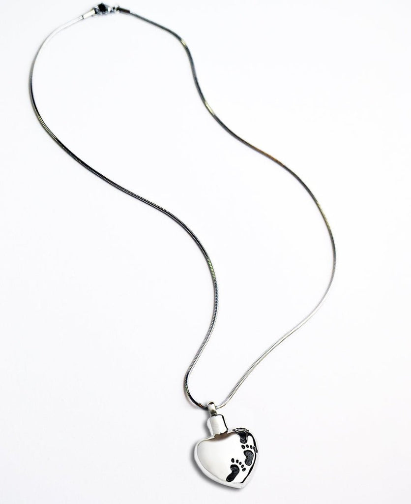 Memorial cremation ashes necklace, heart pendant with footprints, 316L stainless steel, 22-inch chain.