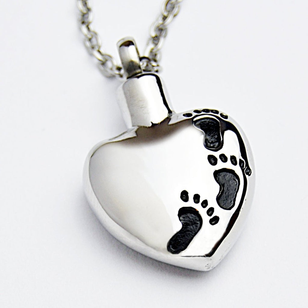 Memorial cremation ashes necklace, heart pendant with footprints, 316L stainless steel, 22-inch chain.