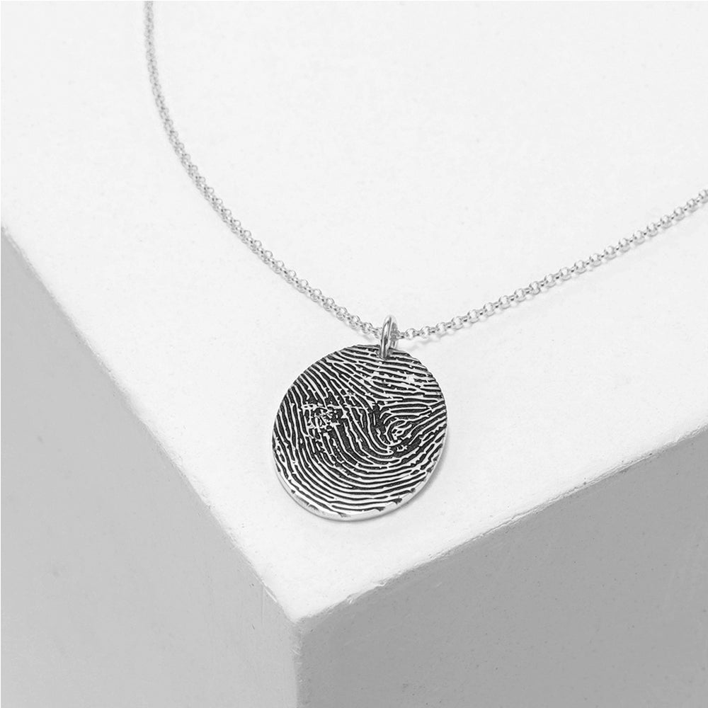 Custom sterling silver fingerprint necklace, round pendant, available in white, gold, or rose gold.