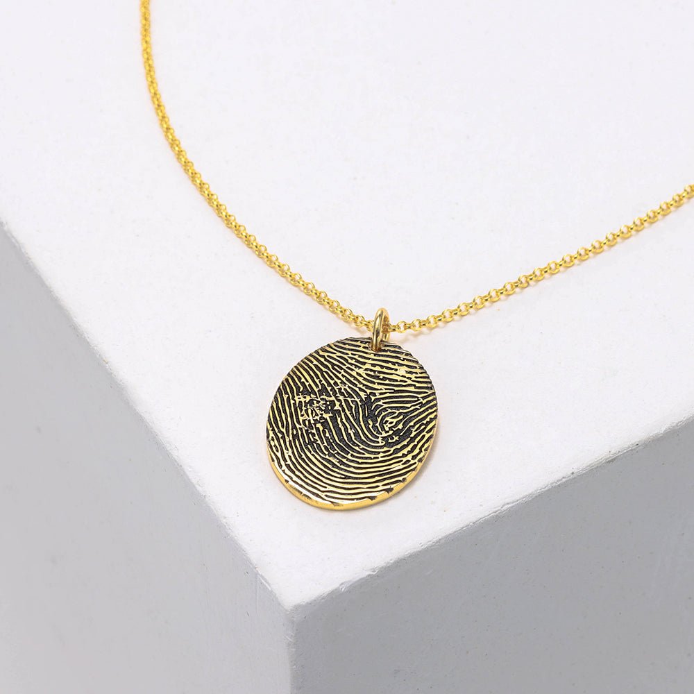 Custom sterling silver fingerprint necklace, round pendant, available in white, gold, or rose gold.