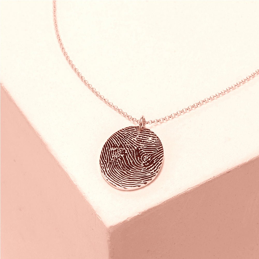 Custom sterling silver fingerprint necklace, round pendant, available in white, gold, or rose gold.