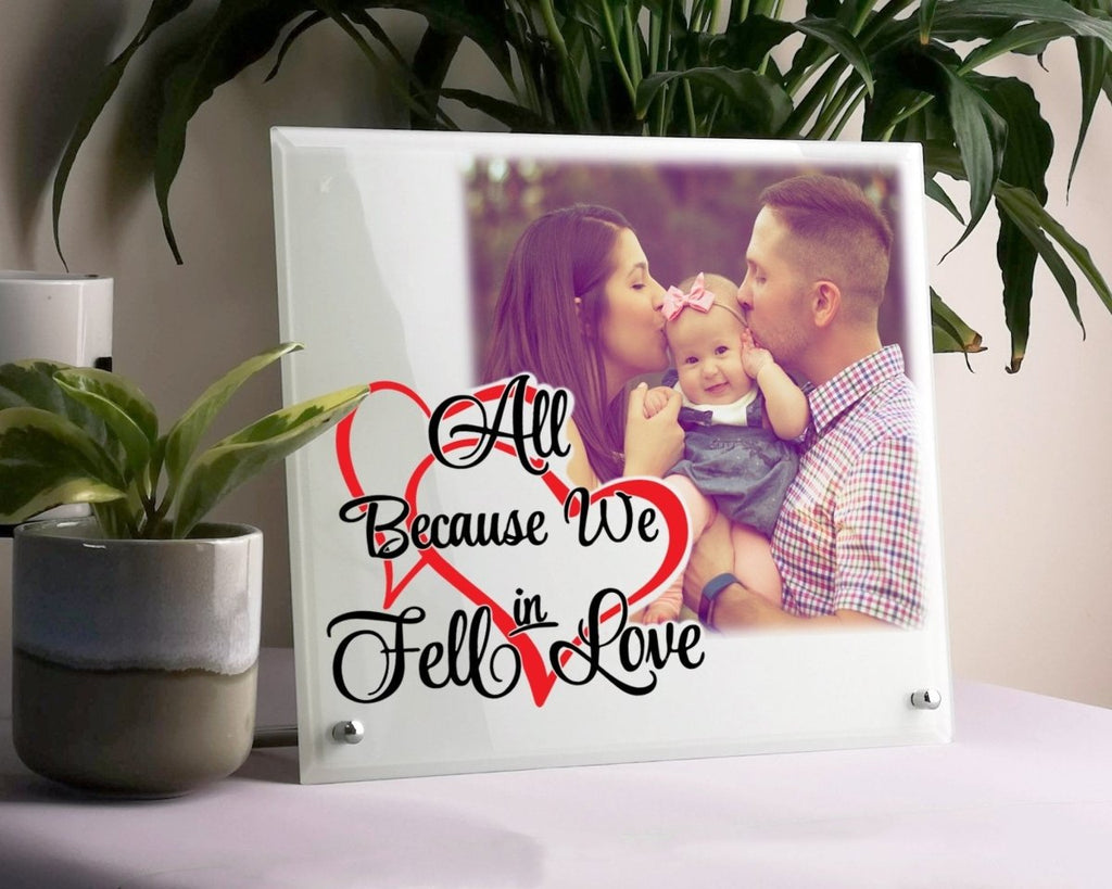 Personalized glass photo display with 'All Because We Fell in Love' text, perfect Valentine's gift.