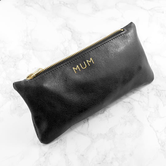 Monogrammed black leather slimline clutch, handmade in the UK, personalized with up to 3 gold initials.