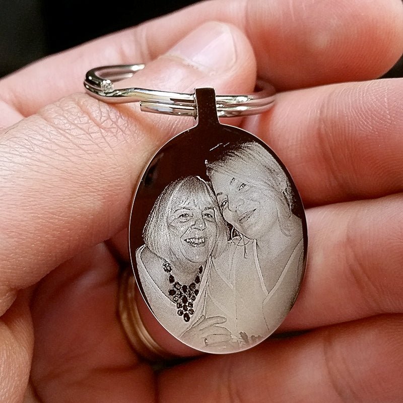 Engraved Oval Photo Keychain in mirror-finished stainless steel, customizable with photos, text, or logos.