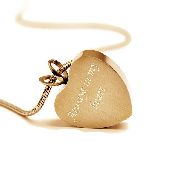 Gold-plated stainless steel heart-shaped cremation pendant with paw print design. 