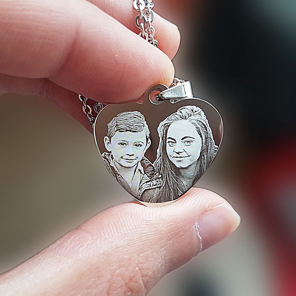 Personalized heart-shaped stainless steel photo necklace, engraved with custom text or image.