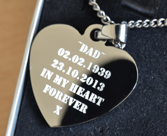 Personalized heart-shaped stainless steel photo necklace, engraved with custom text or image.