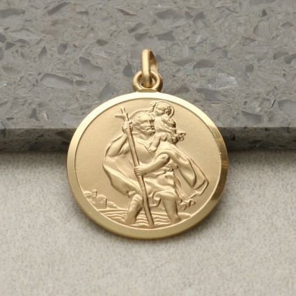9ct Gold St. Christopher pendant featuring traditional safe travel image. Embossed design, measures 18mm in diameter.