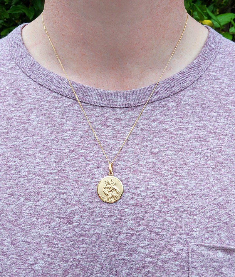 9ct Gold St. Christopher pendant featuring traditional safe travel image. Embossed design, measures 18mm in diameter.
